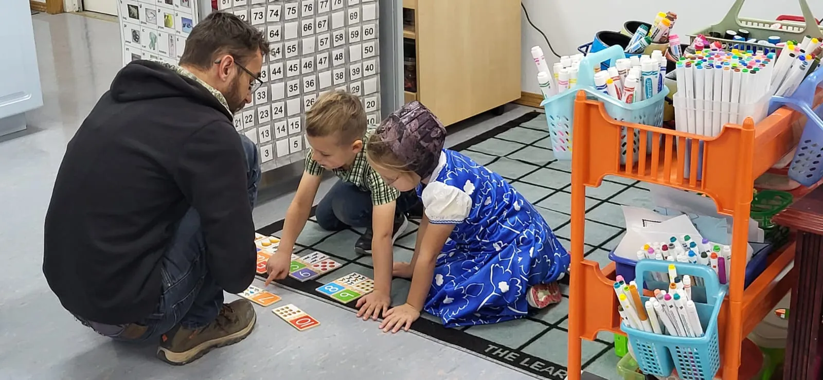 Working on a mathematics problem with kindergarten students